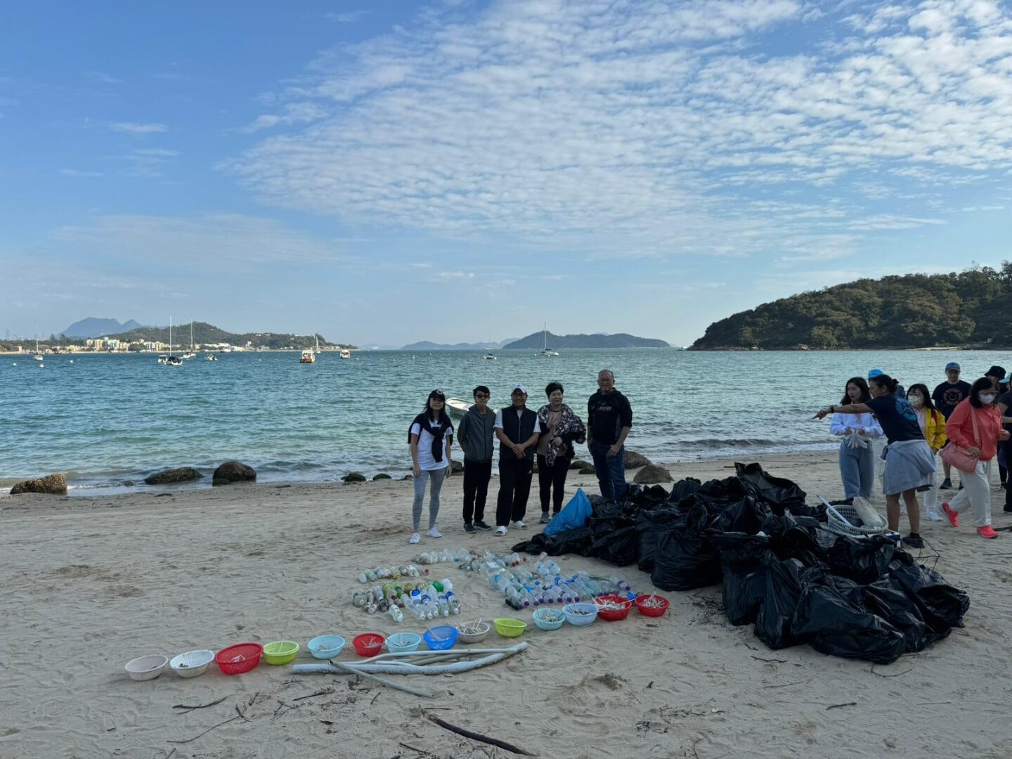Volunteers with sorted plastic waste on Hong Kong beach